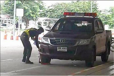 Security Officer clamps Police Car